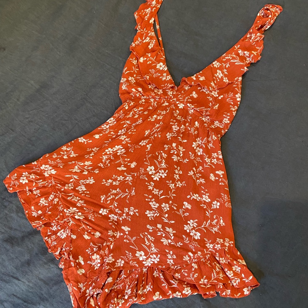 Burnt orange floral romper with ruffles and crisscross back (adjustable)